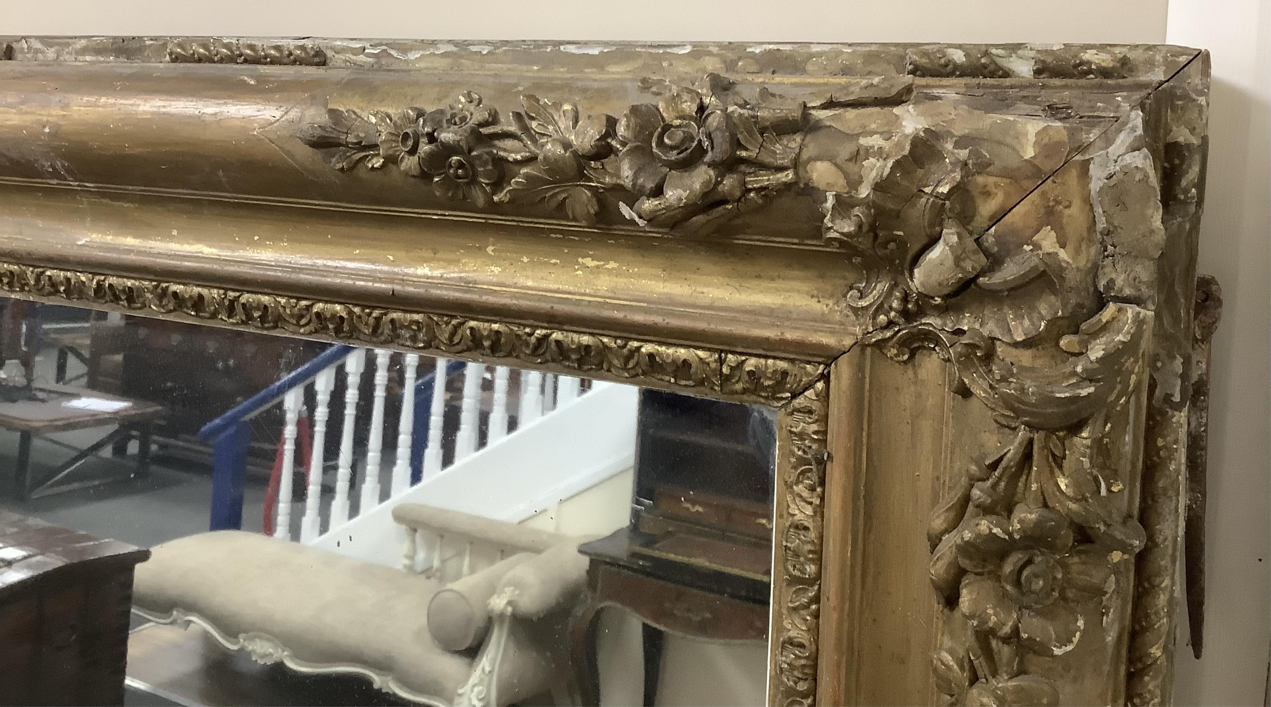 A large Victorian rectangular giltwood and composition overmantel mirror, width 137cm, height 178cm. Condition poor to fair